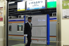 Impeccably dressed station staff hurry along to do their tasks